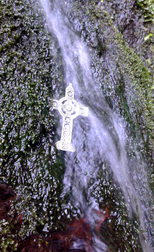 silver floral cross in waterfall at the quarry